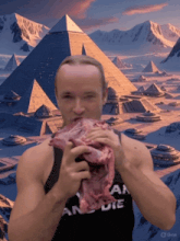 a man eating a large piece of meat in front of pyramids