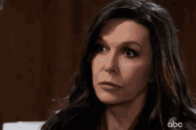 a close up of a woman 's face with a serious look on her face on a tv show .