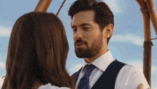 a man with a beard and a woman looking at each other