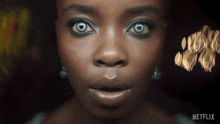 a close up of a woman 's face with a netflix logo on the bottom