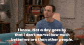 a man is sitting on a couch with a quote that says i know not a day goes by that