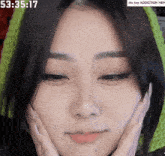 a close up of a woman 's face with the time showing 53 : 35.17
