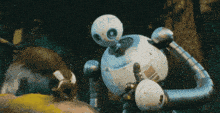a robot is standing next to a squirrel in the dark