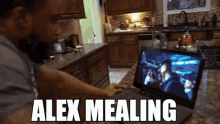 a man is watching a movie on a laptop with alex mealing written on the bottom