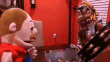 two stuffed animals are standing next to each other on a table