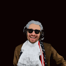 a man wearing a wig and sunglasses has headphones on