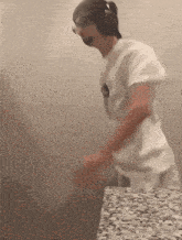 a man wearing headphones is dancing in a bathroom