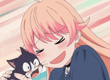 a girl with pink hair holds a black and white cat in her hands