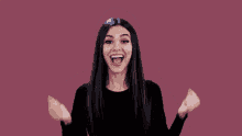 a woman in a black shirt is screaming with her mouth open