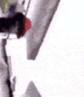 a close up of a person standing next to a white object on a white surface .