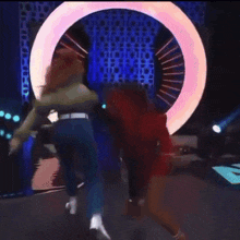a woman in a red dress is being lifted by a man in a blue shirt