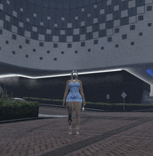 a woman in a blue dress is standing in front of a building that says ' hotel ' on it