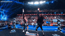two wrestlers are in a wrestling ring with a snickers sign on the floor