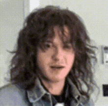 a pixelated image of a woman with long curly hair