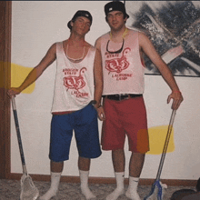 two men wearing tank tops that say badger valley lacrosse camp