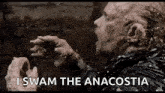 a man with a beard is eating a piece of meat and says `` i swam the anacostia '' .