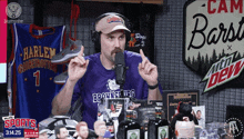 a man wearing a purple shirt that says brownsville ufc talks into a microphone