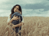 a woman holding a child in a field with the word kepler visible