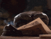 a statue of a monster reading a newspaper