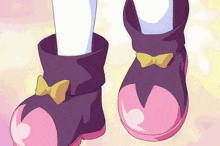 a pair of black and pink boots with a yellow bow