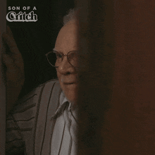 a man with glasses says hello beautiful in front of a son of a grifch logo