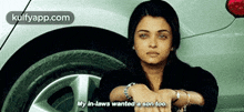 a woman is sitting in front of a car with her hands folded and says my in-laws wanted a son too