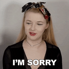 a woman says i 'm sorry in front of a white background