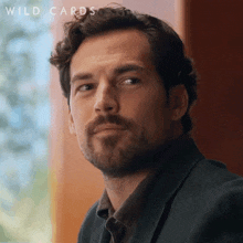 a close up of a man 's face with the words wild cards written on the bottom