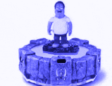 a statue of a man with a mustache stands on top of a blue item