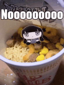 a cup of noodles with a picture of a girl on top that says nooooooo