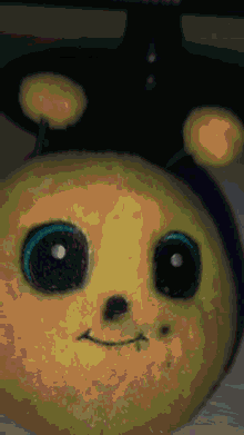 a close up of a stuffed animal with a bee hat on