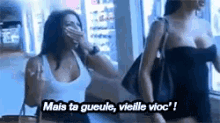 a couple of women standing next to each other with the words mais ta gueule vielle vioc on the bottom