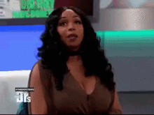a woman is sitting in front of a screen that says the doctors on it