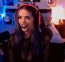 a woman with blue hair wearing headphones and a black shirt