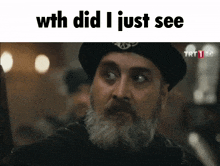 a man with a beard wearing a black hat with the words " with did i just see "