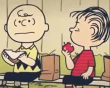 a cartoon of charlie brown eating a sandwich and a boy eating an apple while sitting on a bench .