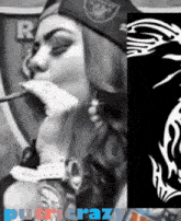 a woman wearing a raiders hat is smoking a cigarette next to a picture of a dragon