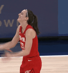a female basketball player wearing a red uniform with the number 22 on it