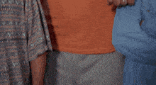 a man wearing an orange t-shirt that says guns don 't kill people