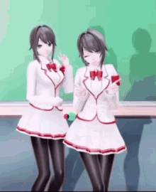 a couple of anime girls are standing next to each other in front of a green board .