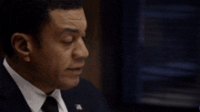 a man in a suit and tie with the words " who else knows about this " behind him