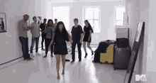 a group of people are dancing together in a room .