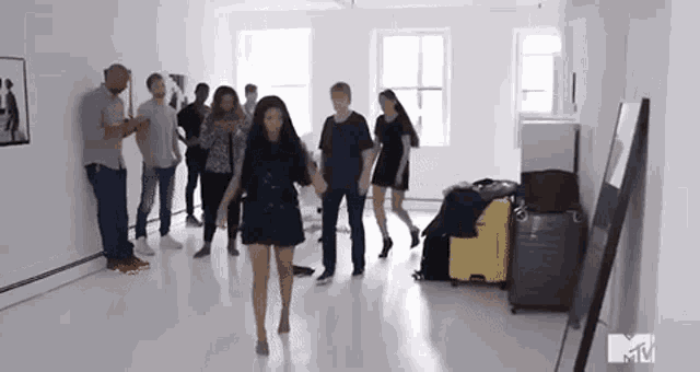 a group of people are dancing together in a room .