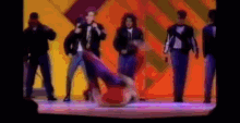 a blurry picture of a group of people dancing on stage