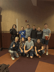 a group of young people posing for a picture one of them is wearing a shirt that says bravo