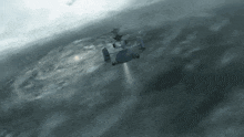 a helicopter is flying over a body of water in a cloudy sky