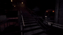 a dark room with stairs leading up to a few pipes