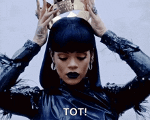 a woman is wearing a crown on her head and saying tot