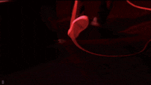 a blurred image of a person laying on the floor with the letter d in the lower right corner