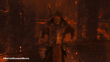 a poster for the mortal kombat movie shows a samurai with a mask on